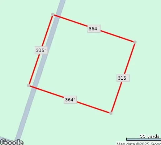 a utility room with dryer and refrigerator