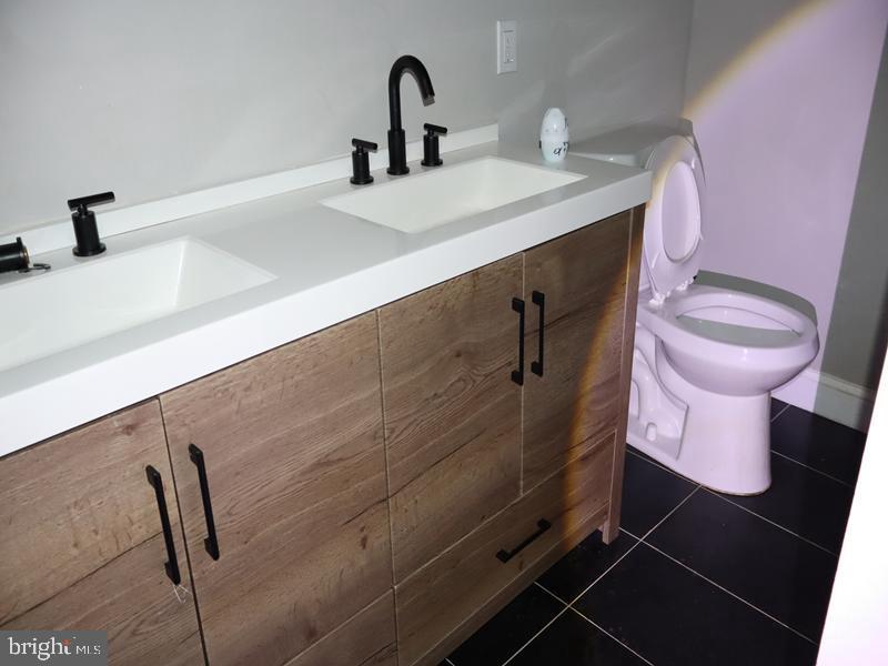 2212 Morris Street Philadelphia, PA 19145 - Photo 11 of 14 a bathroom with a sink toilet and vanity