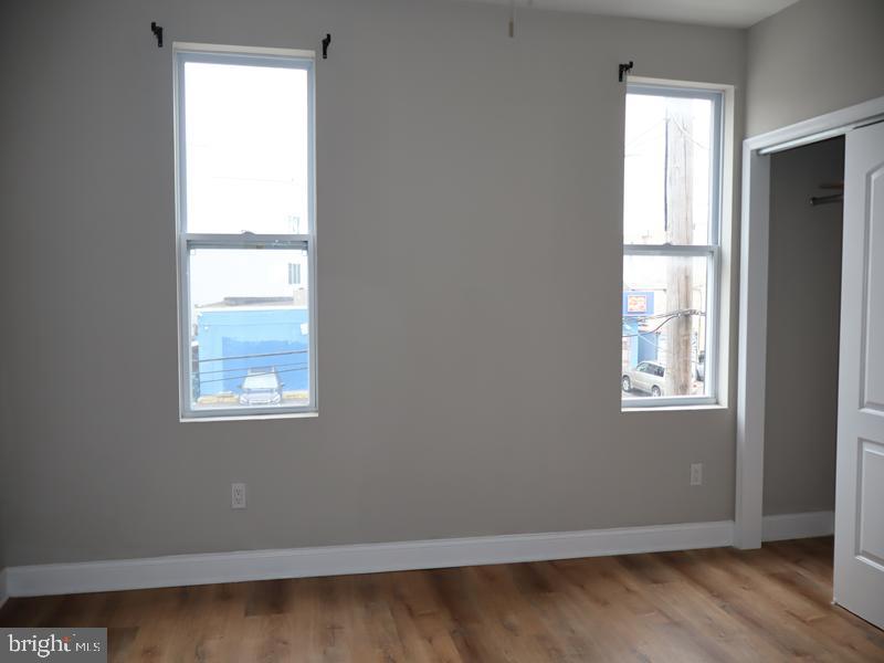 2212 Morris Street Philadelphia, PA 19145 - Photo 9 of 14 an empty room with wooden floor and windows
