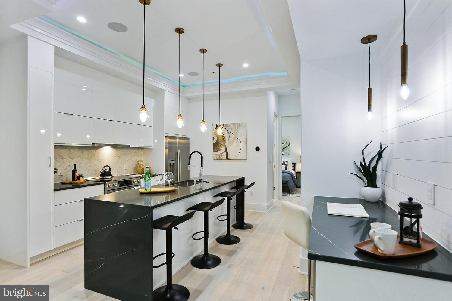 4 R Street Northwest, Unit 3 Washington, DC 20001 - Photo 1 of 35 a kitchen with a sink a counter and chairs