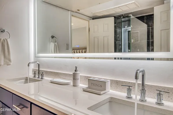 a kitchen with a sink and a wooden floor