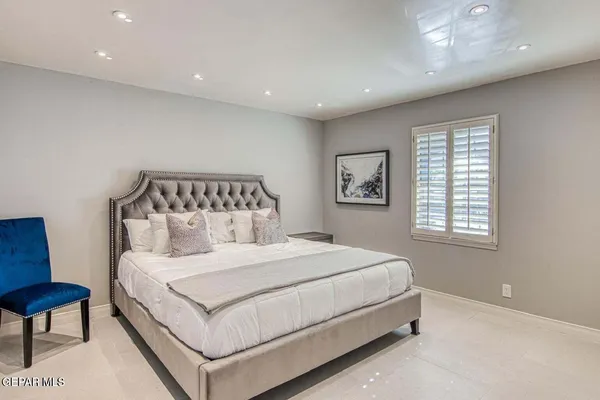 a bedroom with a bed and a couch