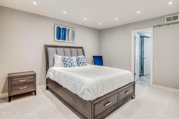 a bed sitting in a room next to a lamp