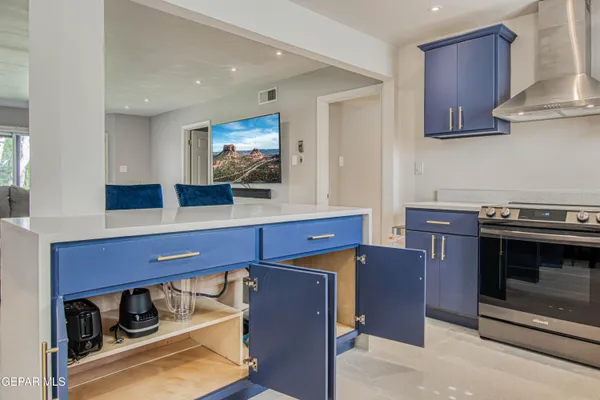 a kitchen with stainless steel appliances granite countertop a stove and a microwave