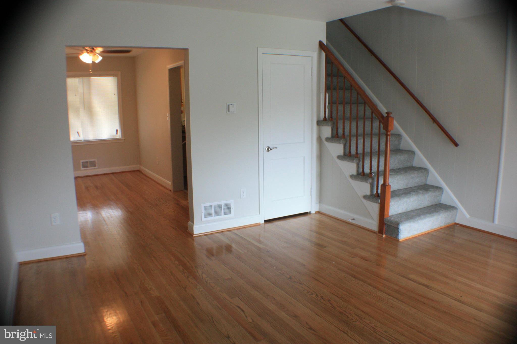 362 Grovethorn Road Baltimore, MD 21220 - Photo 3 of 14 a view of a hallway with wooden floor and staircase