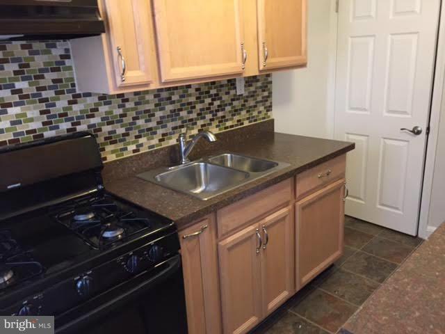 362 Grovethorn Road Baltimore, MD 21220 - Photo 4 of 14 a kitchen with granite countertop a sink stove and cabinets