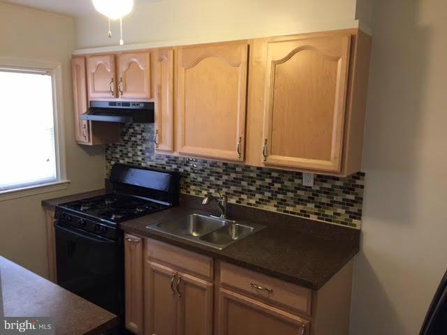 362 Grovethorn Road Baltimore, MD 21220 - Photo 5 of 14 a kitchen with granite countertop a sink and a stove