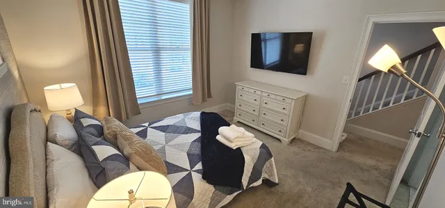 a bedroom with furniture and a flat screen tv