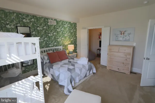 a bed room with a bed and a chair