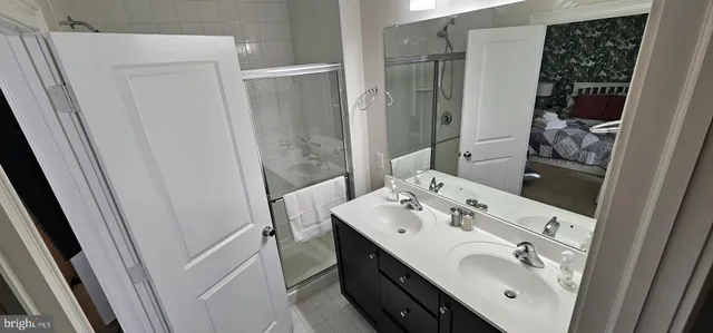 a bathroom with a sink a mirror and shower