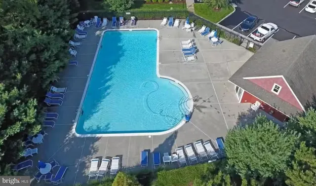 a view of a swimming pool with outdoor seating and plants
