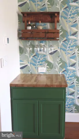 a room with water heater and wooden cabinets