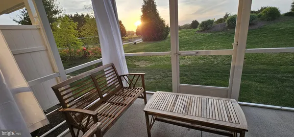 a view of balcony with wooden floor and fence
