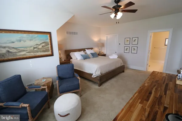 a bedroom with a bed window and couch