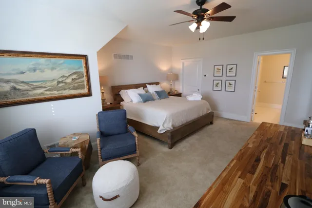 a bedroom with a bed window and couch