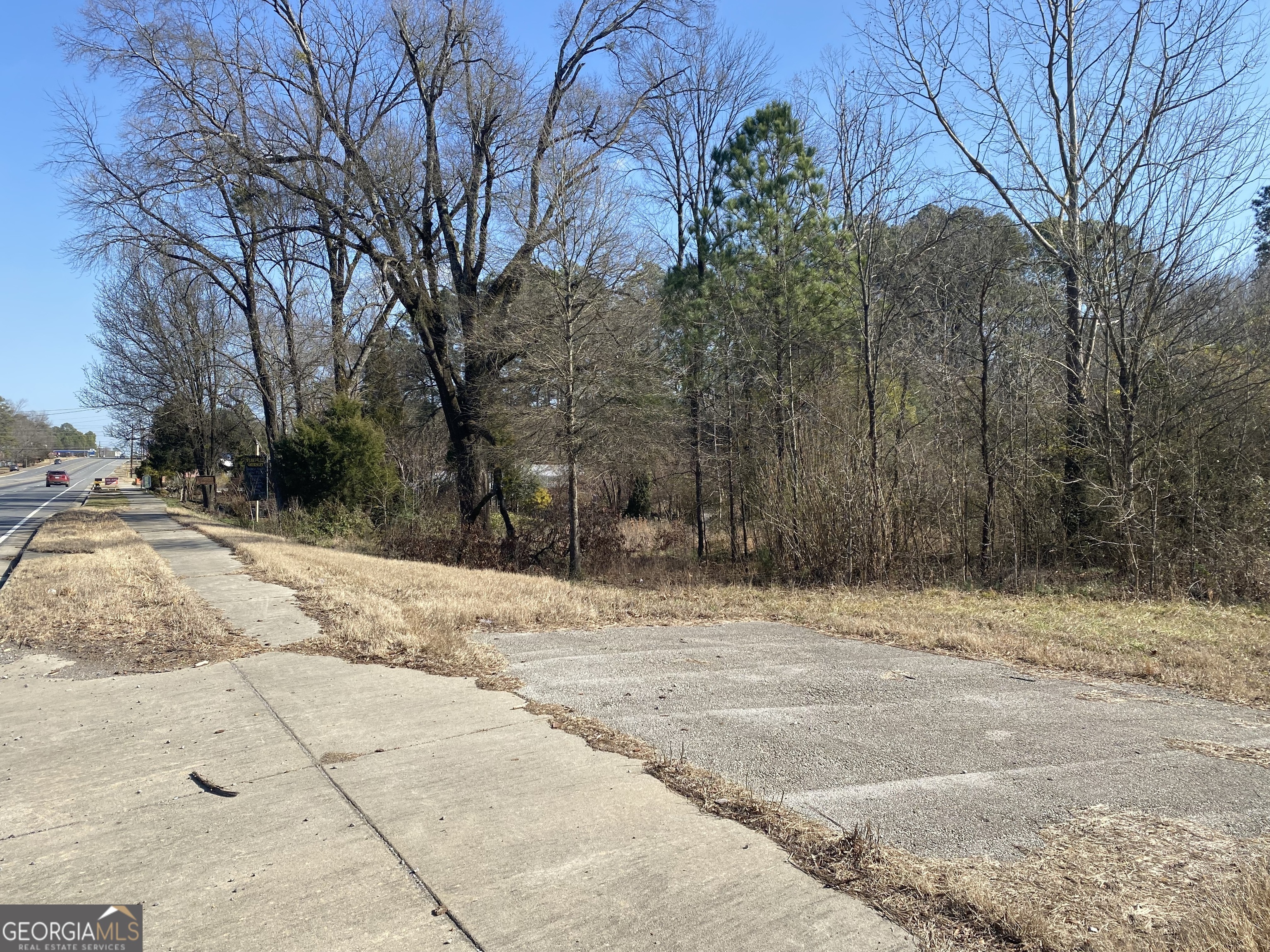 a view of a yard with snow on the road