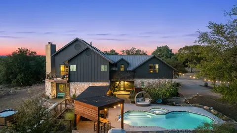 a backyard of a house with table and chairs