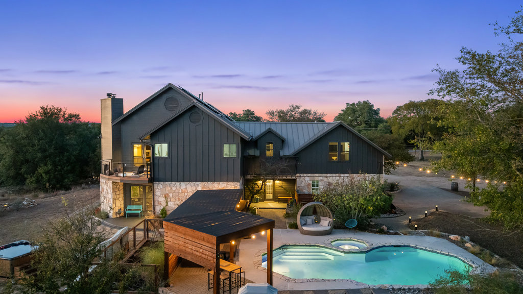 a backyard of a house with table and chairs