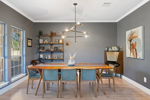 a dining room with furniture and window