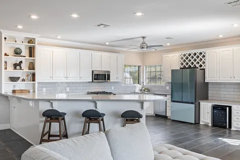 a kitchen with stainless steel appliances granite countertop a refrigerator and microwave