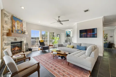 a living room with furniture fireplace and window