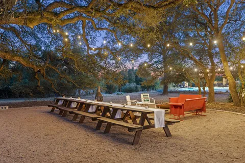 a backyard of a house with table and chairs