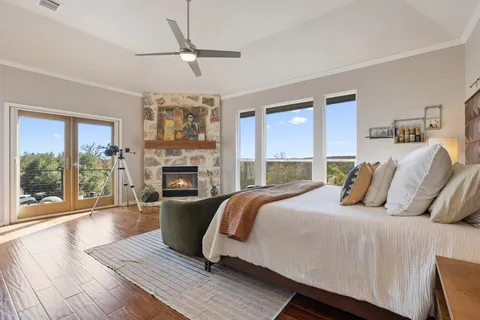 a bedroom with a balcony a bed and a fireplace