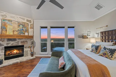 a bedroom with a bed and a fireplace