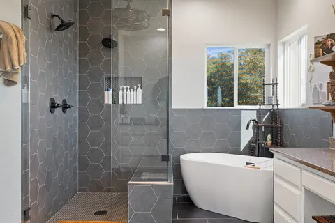 a bathroom with a sink a window and a shower