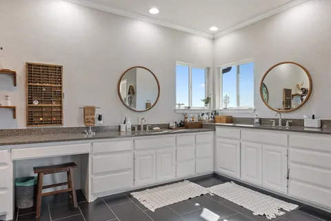 a bathroom with a double vanity sink and a mirror