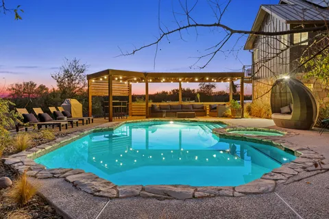 a view of a backyard with swimming pool