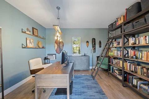 a dining room with furniture and a book shelf