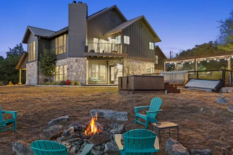 a view of a house with backyard and sitting area
