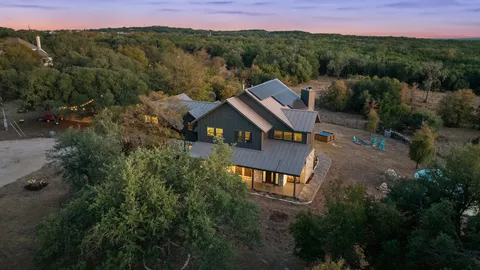 an aerial view of a house with a yard