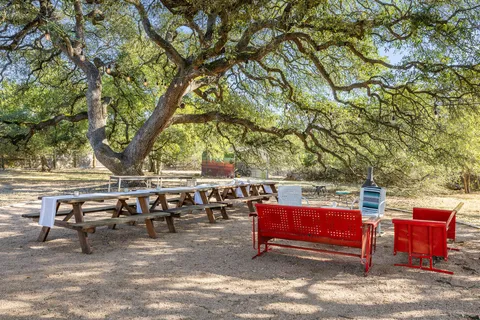 an outdoor sitting area with couch and a barbeque