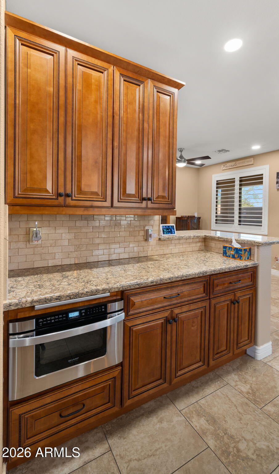 1957 South Talbot Circle Mesa, AZ 85209 - Photo 27 of 35 a kitchen with stainless steel appliances granite countertop a stove a sink and a microwave