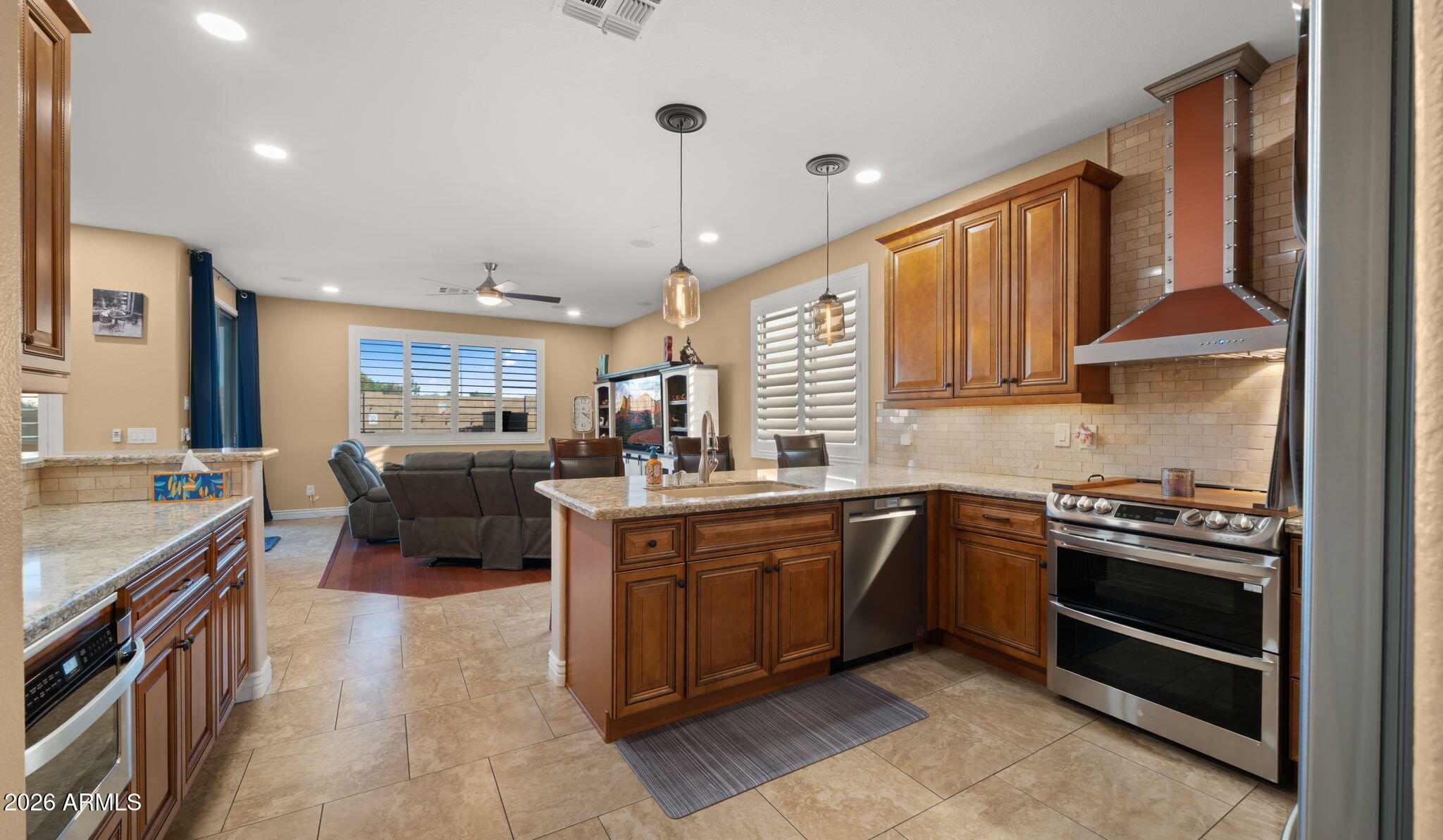 1957 South Talbot Circle Mesa, AZ 85209 - Photo 4 of 35 a kitchen with stainless steel appliances granite countertop a sink a stove and a refrigerator