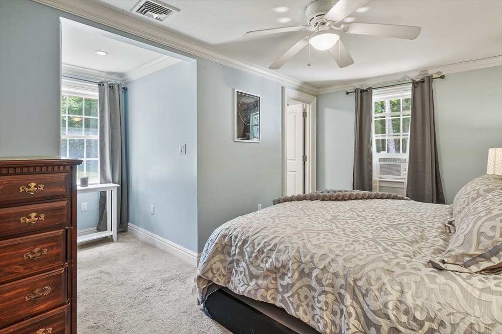 153 Sherbert Road Ashburnham, MA 01430 - Photo 17 of 32 a bedroom with a bed and a chandelier