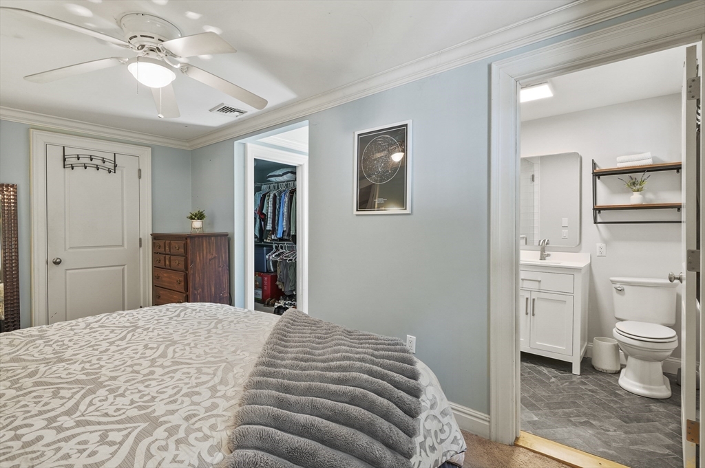 153 Sherbert Road Ashburnham, MA 01430 - Photo 18 of 32 a bedroom with a large bed and a chandelier