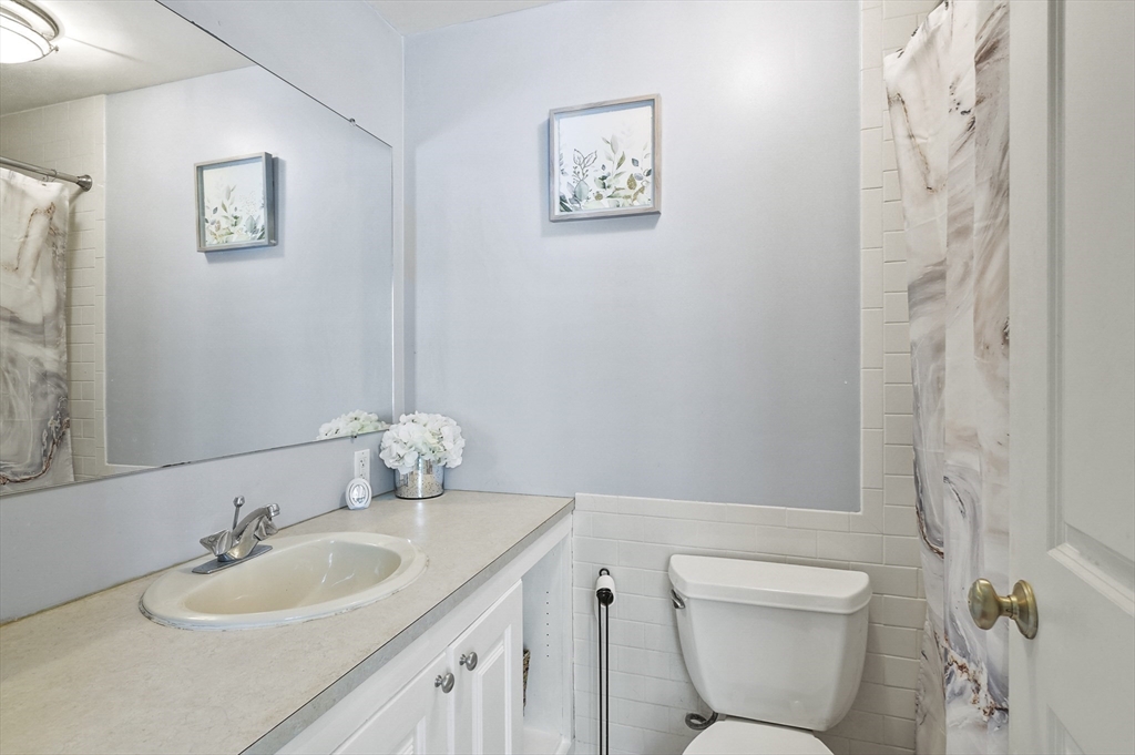 153 Sherbert Road Ashburnham, MA 01430 - Photo 22 of 32 a bathroom with a granite countertop sink a toilet and a mirror