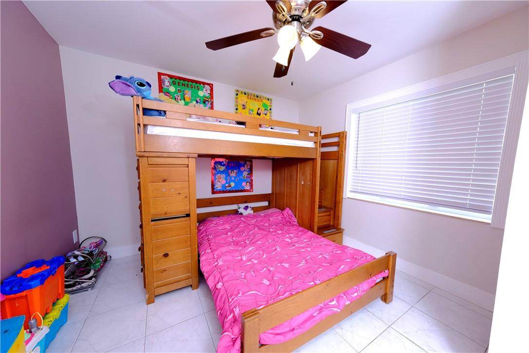 10670 Ember Street Boca Raton, FL 33428 - Photo 12 of 32 a bedroom with a bed and a window
