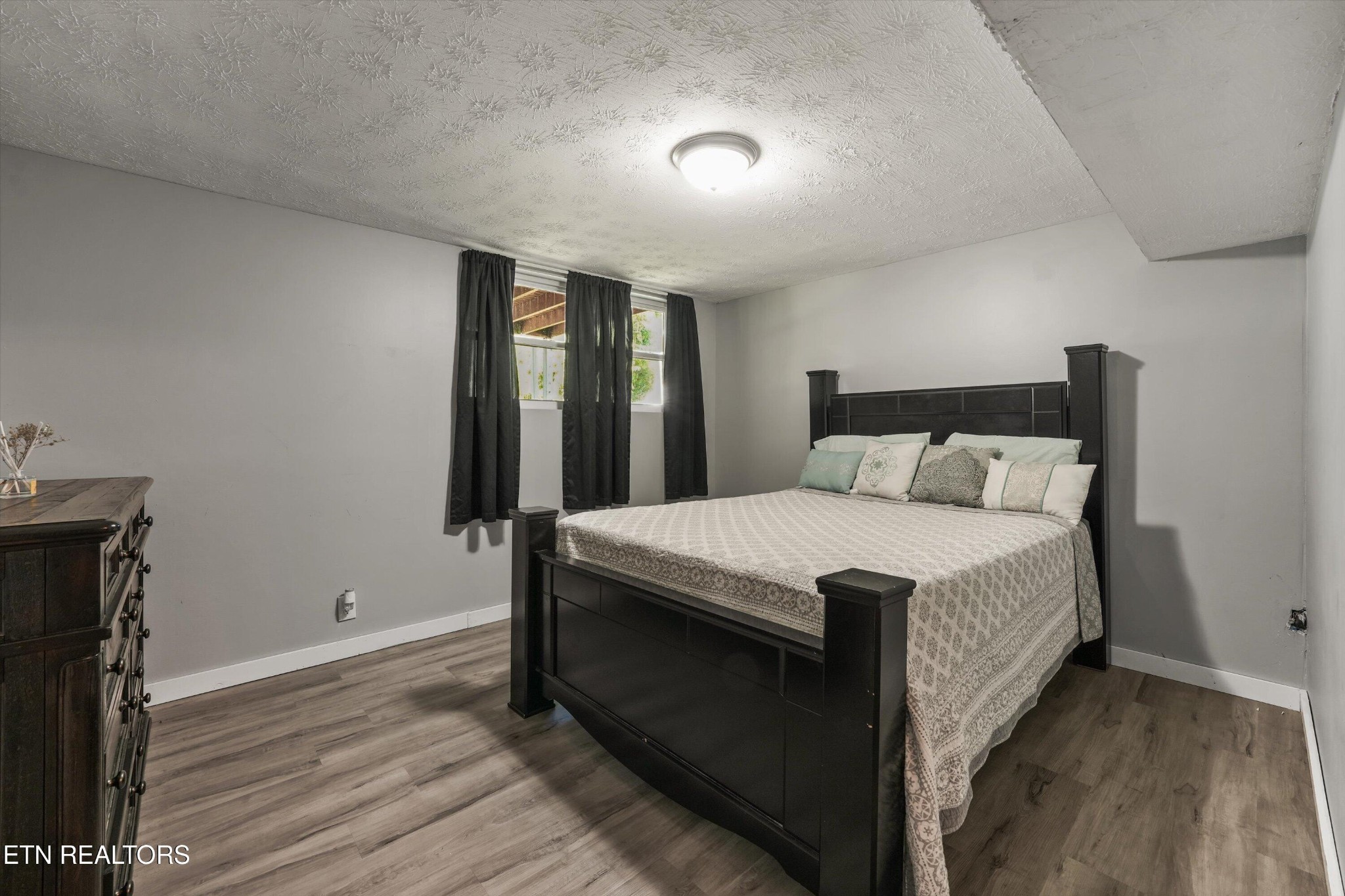 7613 Fall Wind Court Powell, TN 37849 - Photo 25 of 38 a bed sitting in a bedroom next to a window