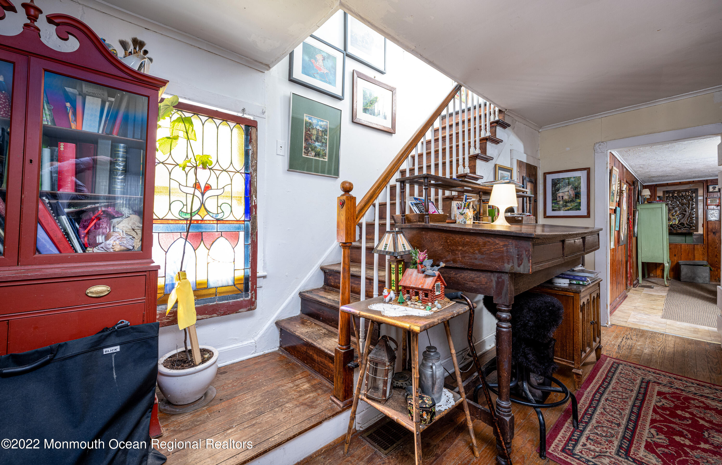 295 Newtons Corner Road Howell, NJ 07731 - Photo 21 of 42 a living room with furniture a piano and a bookshelf