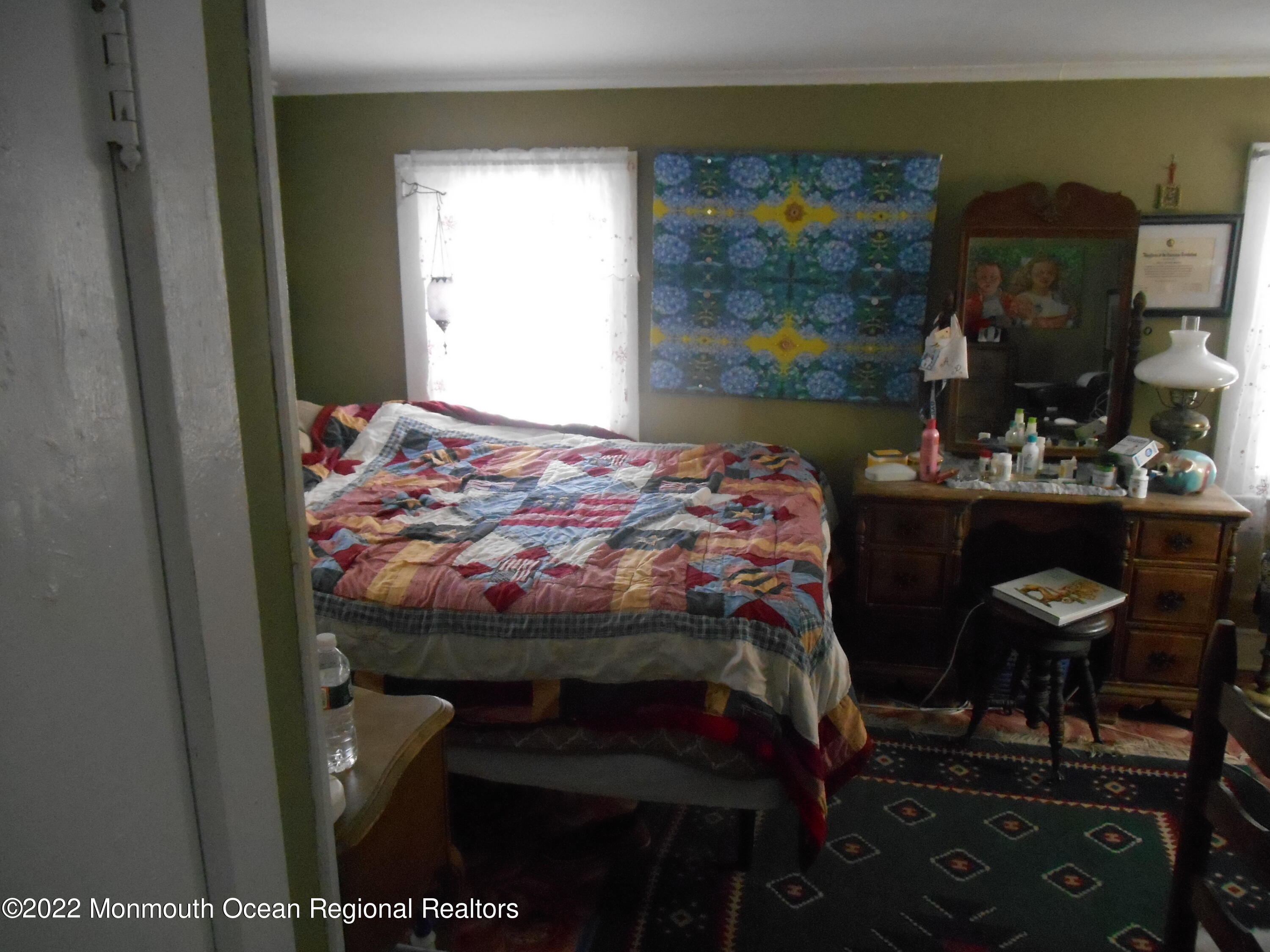 295 Newtons Corner Road Howell, NJ 07731 - Photo 37 of 42 a bedroom with a bed and a table in it