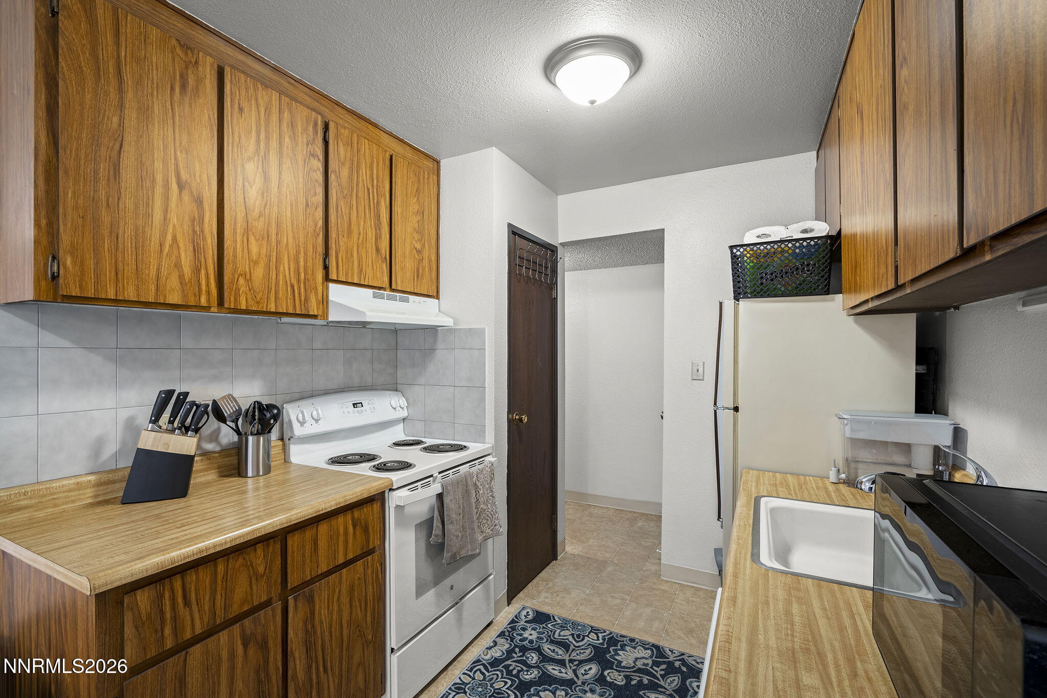 400 South Saliman Road, Unit 129 Carson City, NV 89701 - Photo 4 of 15 a kitchen with a sink and a stove top oven
