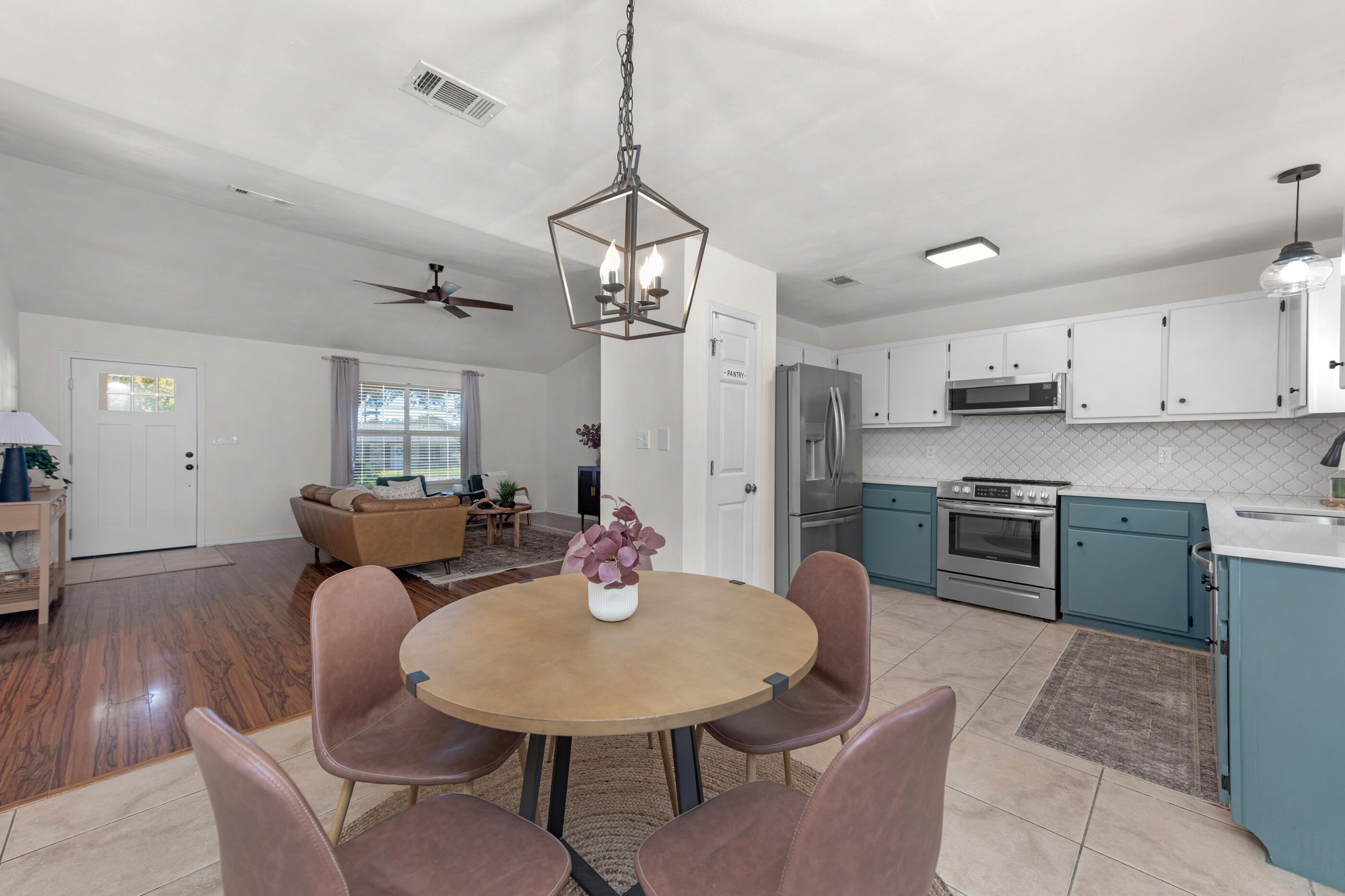 2709 Augustus Road Navarre, FL 32566 - Photo 13 of 46 a living room with stainless steel appliances furniture a dining table and chairs