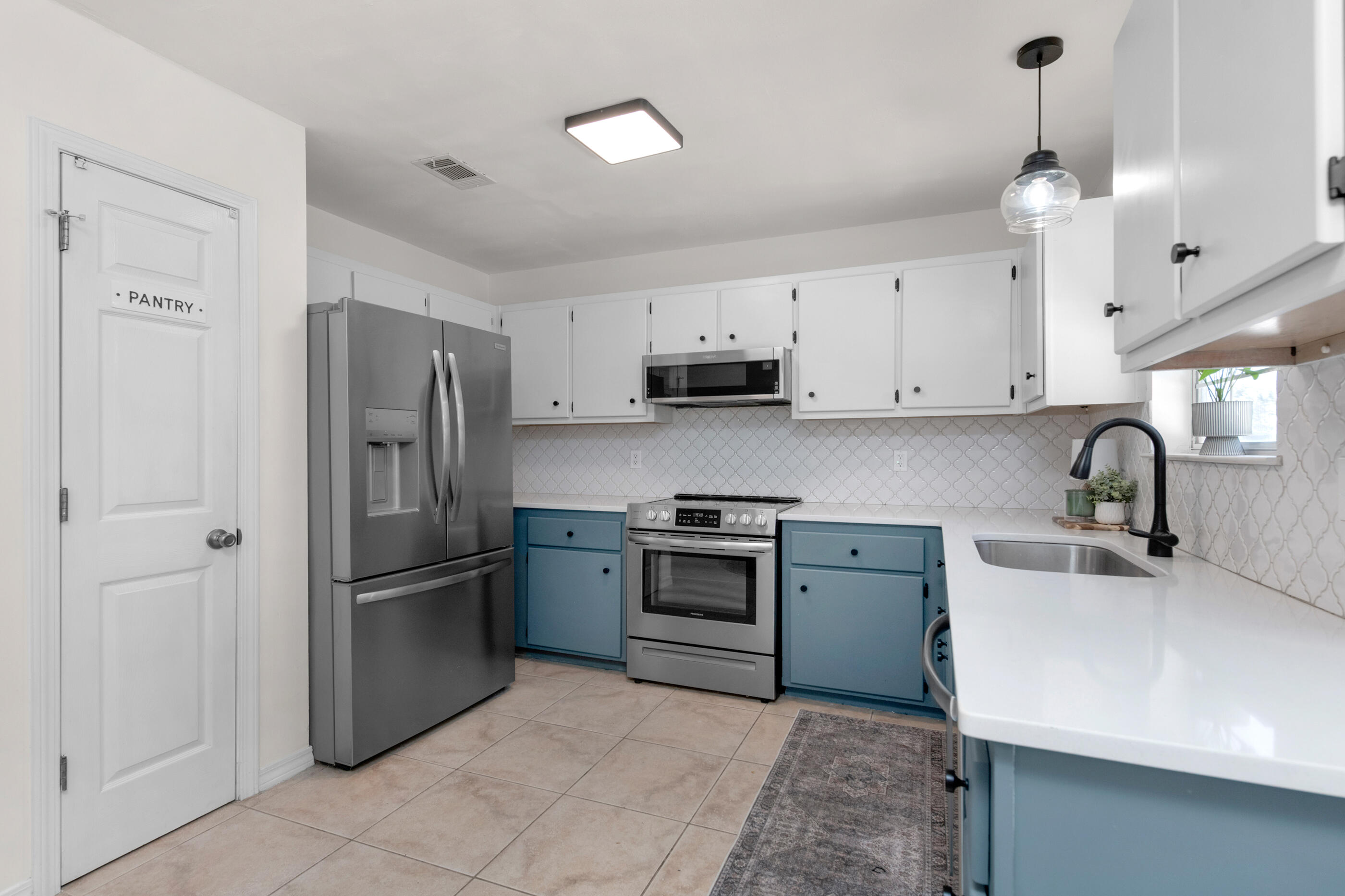 2709 Augustus Road Navarre, FL 32566 - Photo 14 of 46 a kitchen with stainless steel appliances granite countertop a refrigerator sink and stove