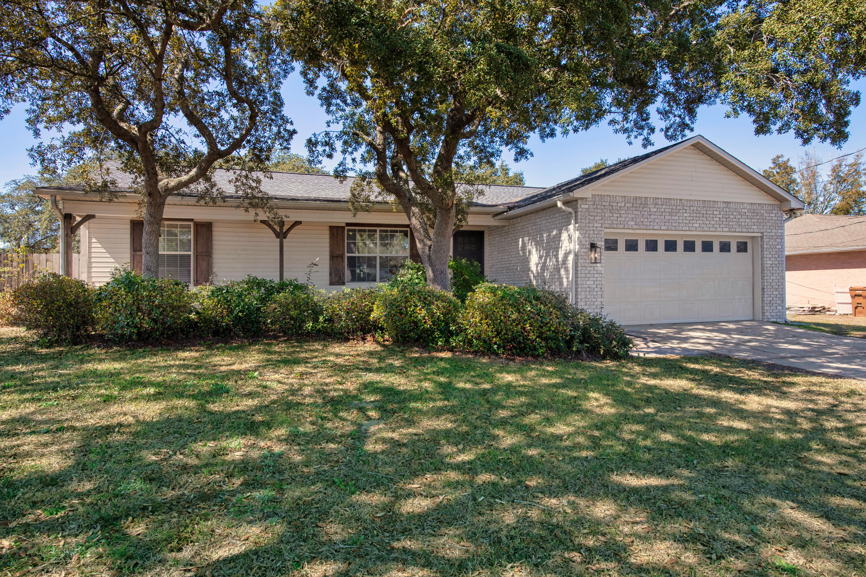 2709 Augustus Road Navarre, FL 32566 - Photo 2 of 46 a front view of a house with garden