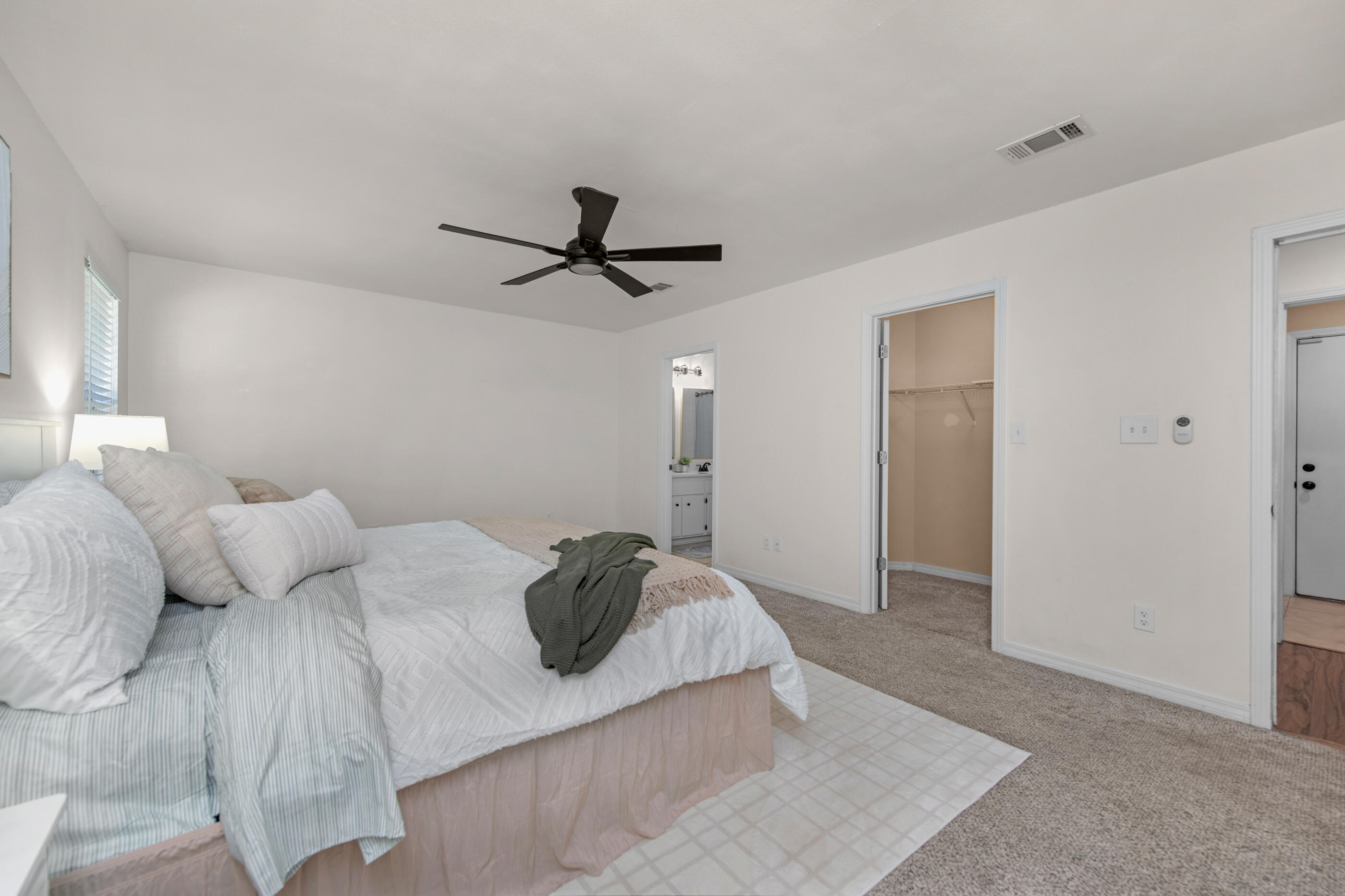 2709 Augustus Road Navarre, FL 32566 - Photo 29 of 46 a bedroom with a large bed and a ceiling fan