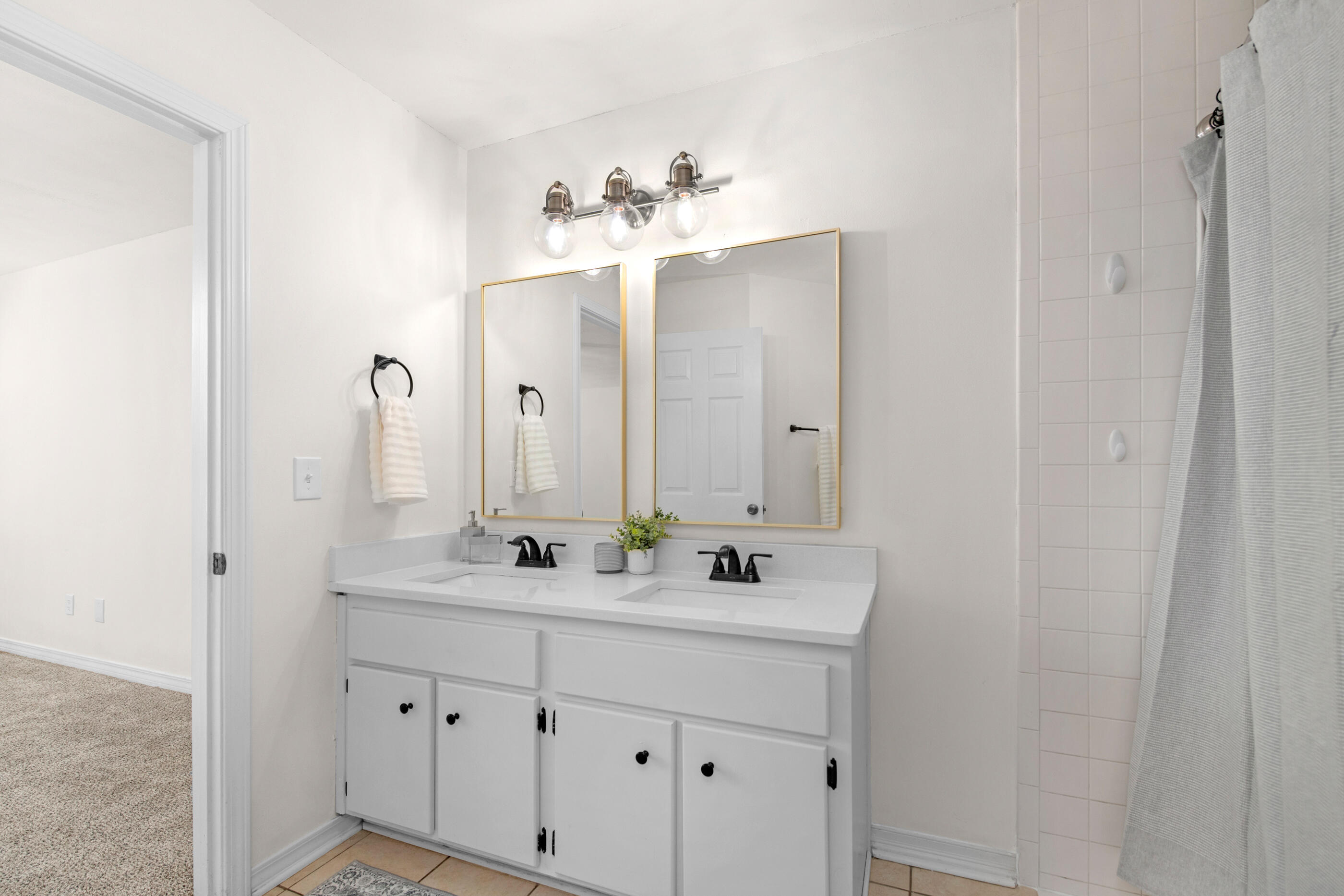 2709 Augustus Road Navarre, FL 32566 - Photo 32 of 46 a bathroom with a double vanity sink and a mirror